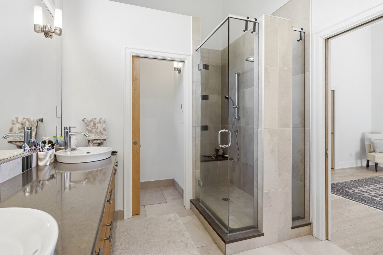 Primary ensuite with walk-in shower and dual vanity