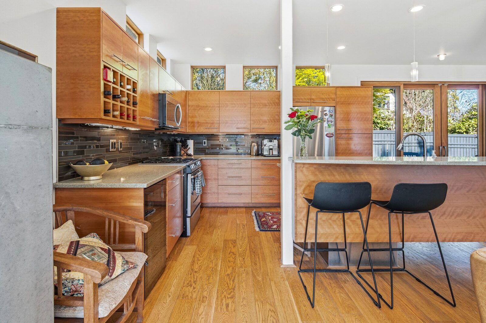 Kitchen with gas range, custom cabinetry, and clerestory windows