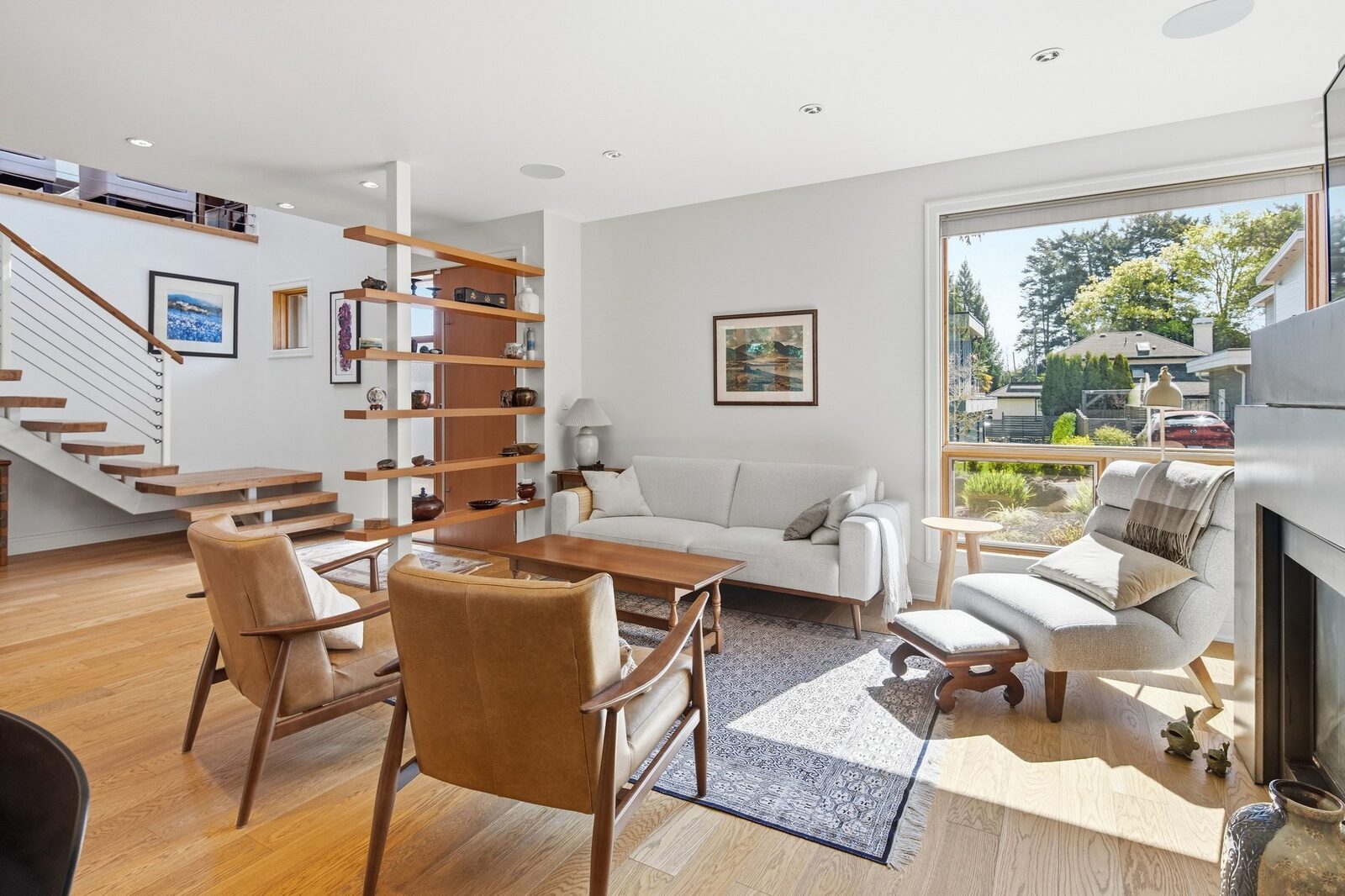 Living room with floor-to-ceiling windows and view to staircase