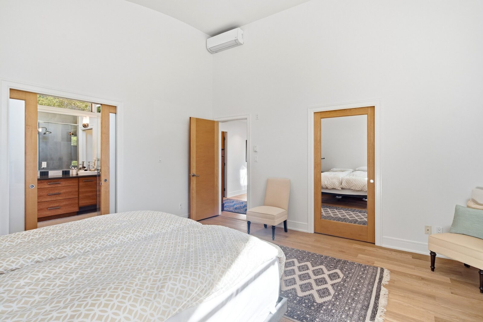 Primary bedroom with vaulted ceiling and ensuite access